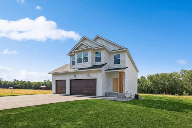 view of front facade featuring a garage, concrete driveway, and a front yard