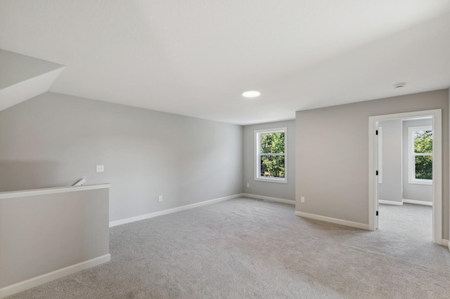 empty room with light carpet and baseboards