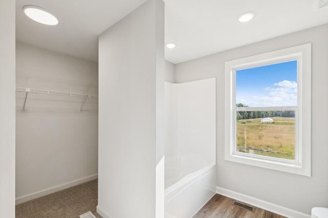 walk in closet with wood finished floors and visible vents