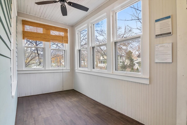 unfurnished sunroom featuring ceiling fan