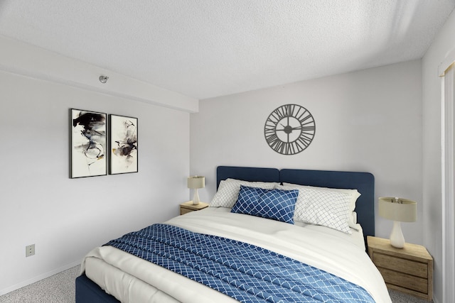 bedroom featuring a textured ceiling and carpet floors