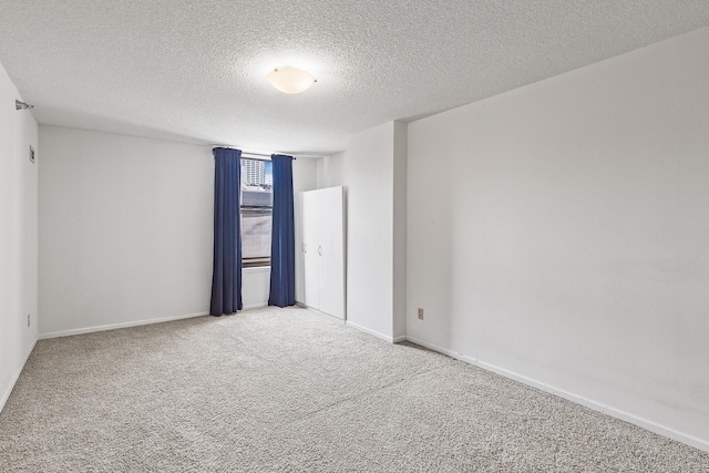 empty room featuring carpet floors and a textured ceiling