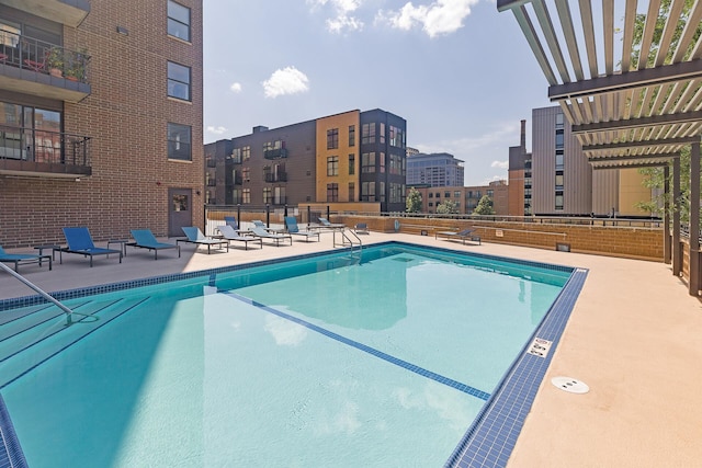 view of pool with a pergola and a patio area