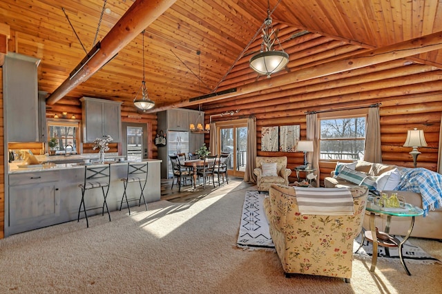 living room with beam ceiling, high vaulted ceiling, carpet floors, and wooden ceiling