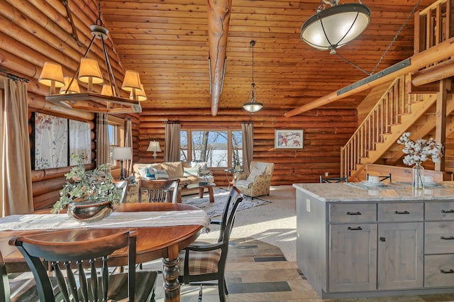 dining room featuring wood ceiling, beam ceiling, high vaulted ceiling, and stairs