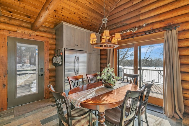 dining area featuring a chandelier, rustic walls, wood ceiling, and vaulted ceiling