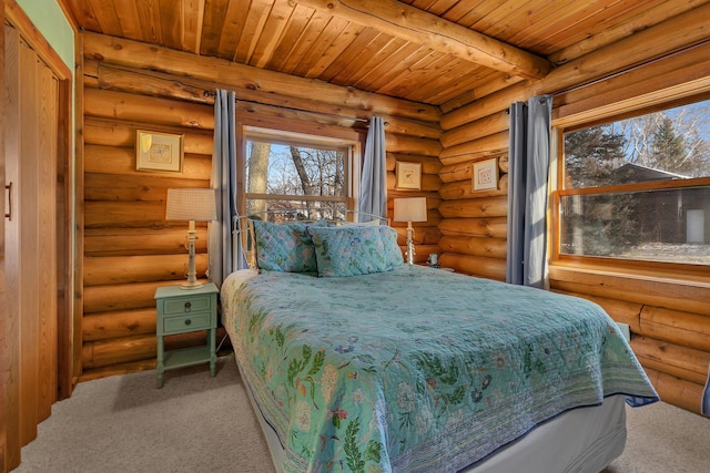 bedroom with beam ceiling, wooden ceiling, and carpet