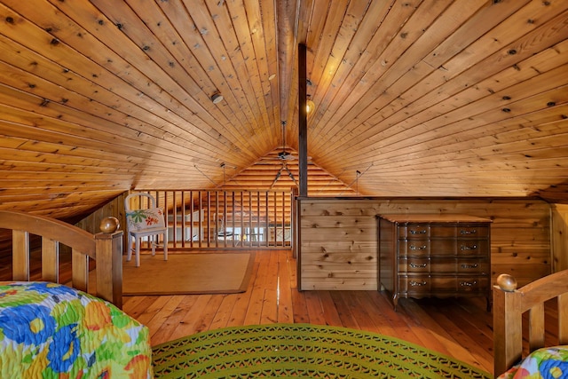 unfurnished bedroom with wood ceiling, wooden walls, vaulted ceiling with beams, and hardwood / wood-style flooring