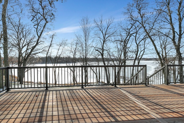 wooden terrace featuring a water view