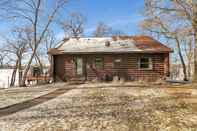 cabin featuring log siding