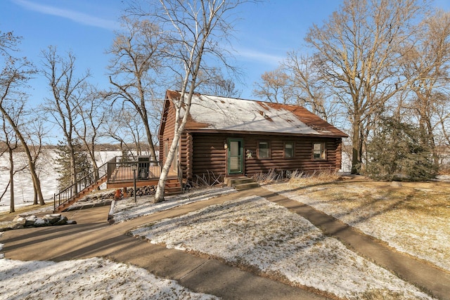 view of front of house featuring log siding and a wooden deck