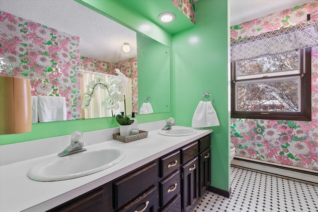 bathroom featuring a baseboard radiator, a textured ceiling, toilet, and vanity