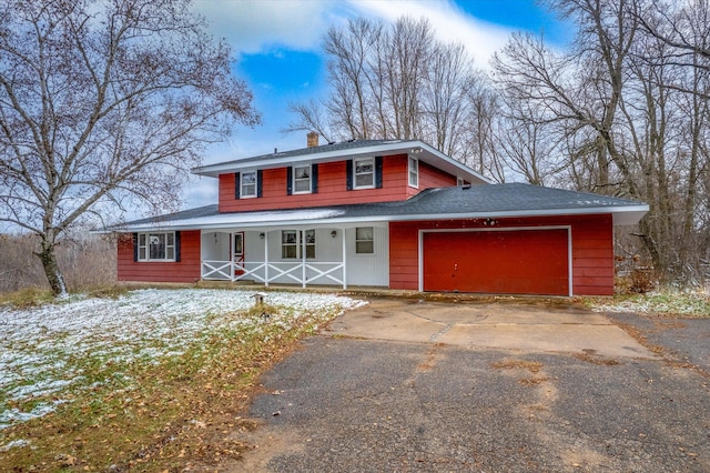 view of front facade with covered porch and a garage