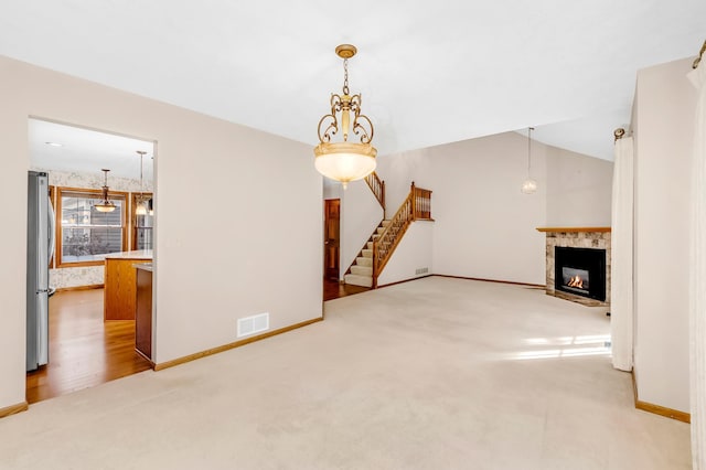 unfurnished living room featuring light carpet