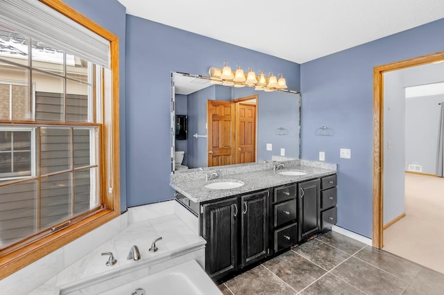 bathroom featuring tile patterned floors, a bathtub, and vanity