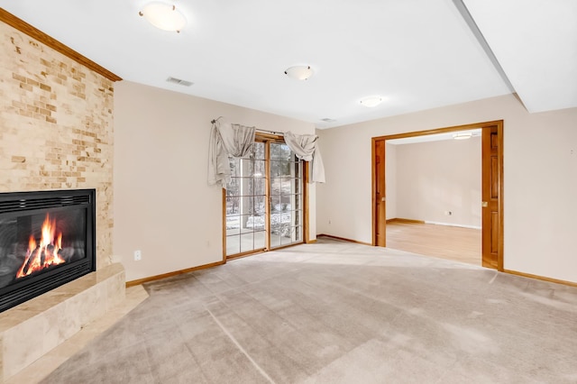 unfurnished living room featuring light carpet and a fireplace