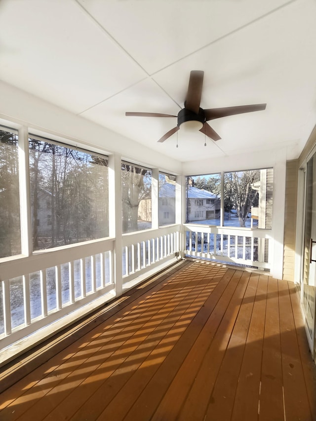 unfurnished sunroom with plenty of natural light and ceiling fan