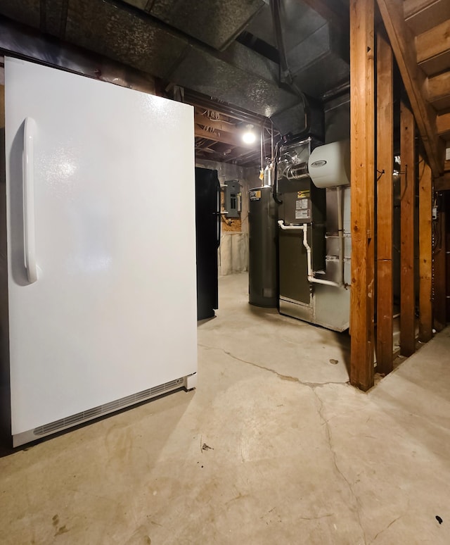 basement featuring electric panel, gas water heater, and white refrigerator