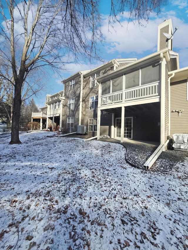 exterior space with a sunroom and cooling unit