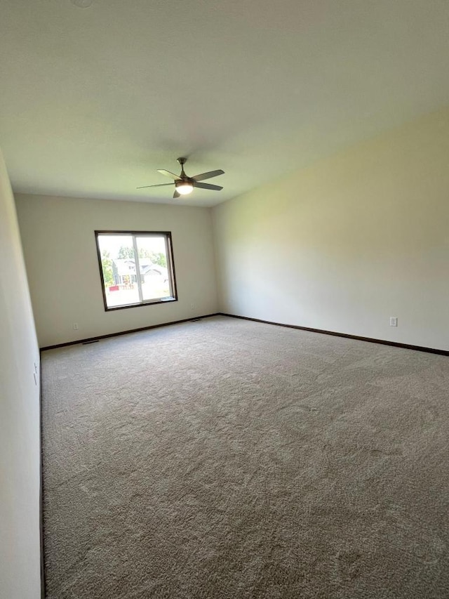 empty room with carpet flooring and ceiling fan