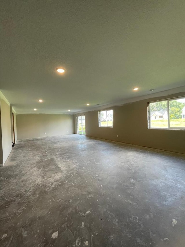 spare room with a textured ceiling and a wealth of natural light