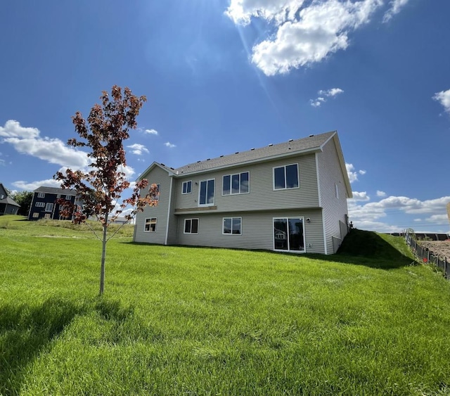 rear view of property with a lawn