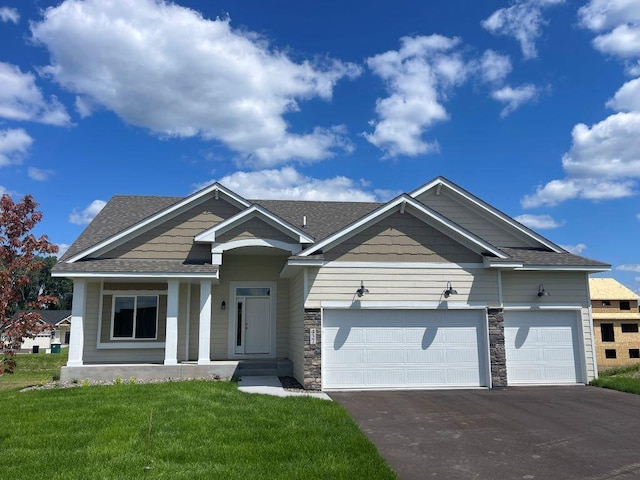 view of front of home featuring a front yard and a garage