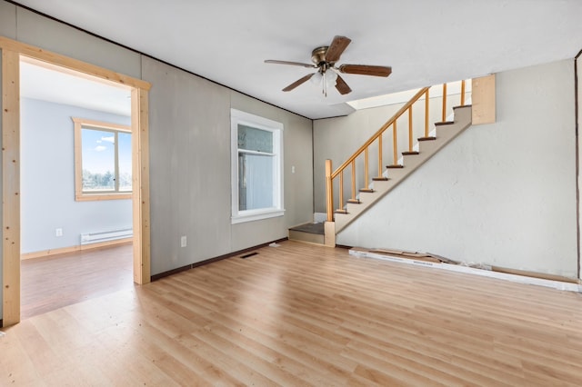 unfurnished living room with ceiling fan, light hardwood / wood-style floors, and a baseboard radiator