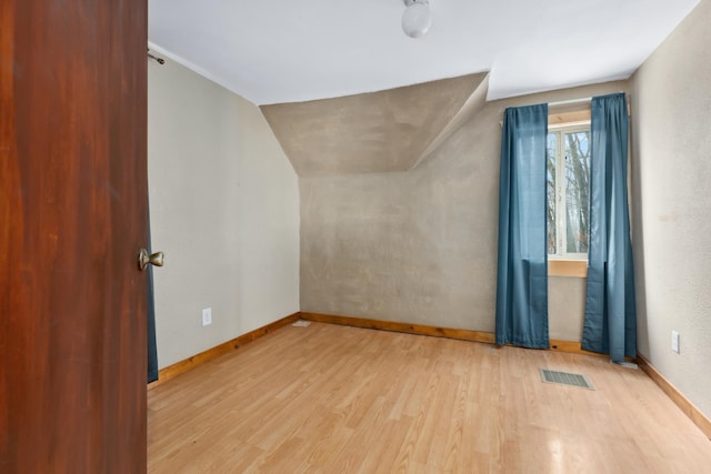 bonus room featuring light hardwood / wood-style flooring and lofted ceiling