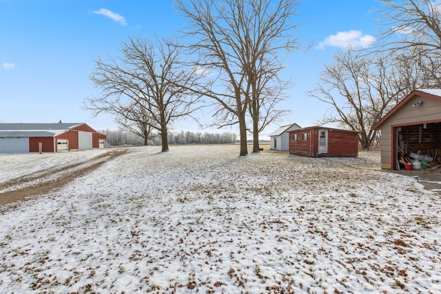 snowy yard with an outbuilding