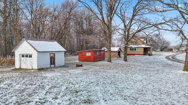 yard layered in snow with an outdoor structure