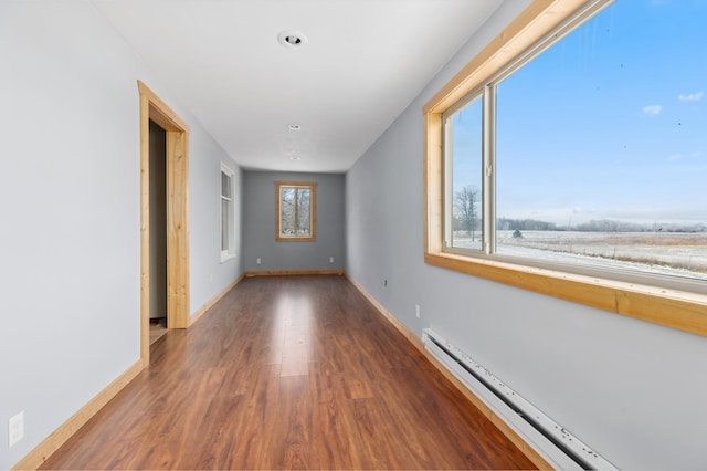 61684 260th St, Hewitt, MN 56453 - spare room with a baseboard heating unit, baseboards, and wood finished floors