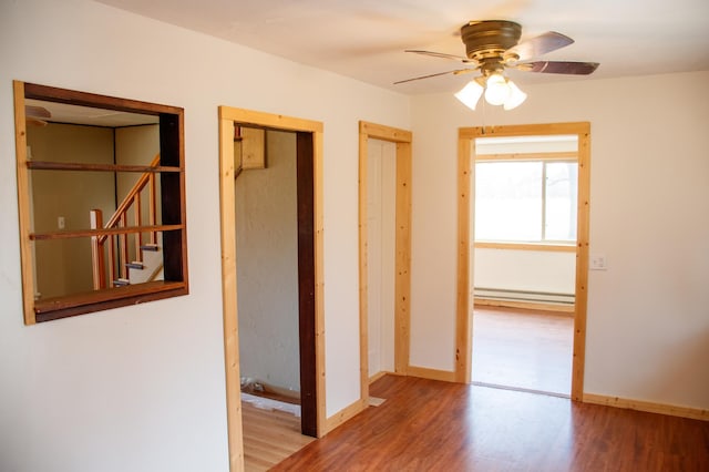 61684 260th St, Hewitt, MN 56453 - interior space featuring baseboards, wood finished floors, and baseboard heating