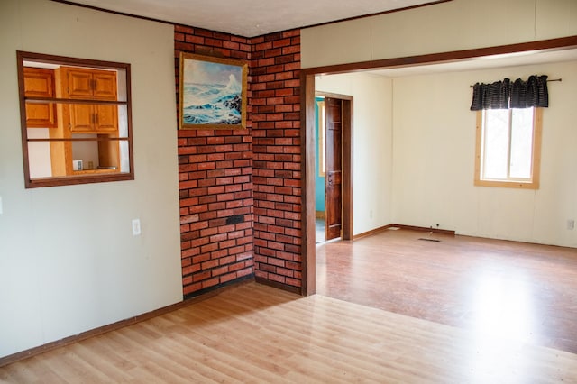 61684 260th St, Hewitt, MN 56453 - unfurnished room featuring visible vents, light wood finished floors, baseboards, and brick wall