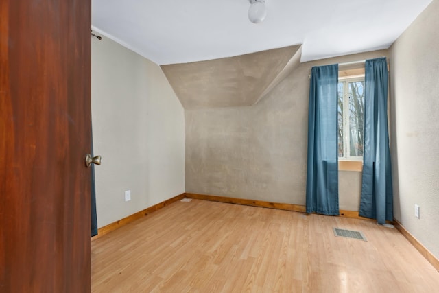 61684 260th St, Hewitt, MN 56453 - bonus room featuring lofted ceiling, wood finished floors, visible vents, and baseboards