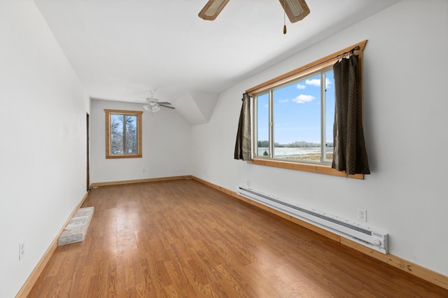 61684 260th St, Hewitt, MN 56453 - additional living space with light wood-type flooring, baseboards, visible vents, baseboard heating, and a ceiling fan