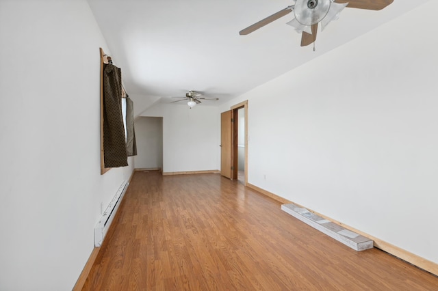 61684 260th St, Hewitt, MN 56453 - unfurnished living room with light wood-type flooring, ceiling fan, baseboards, and a baseboard radiator