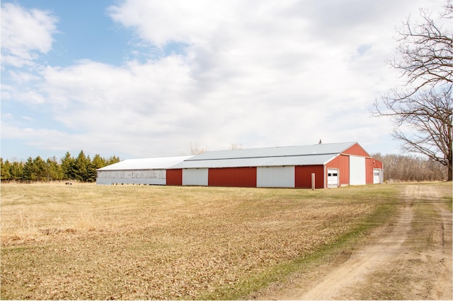 61684 260th St, Hewitt, MN 56453 - view of pole building with driveway and a lawn