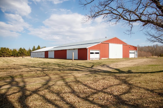 61684 260th St, Hewitt, MN 56453 - view of pole building featuring a lawn and dirt driveway