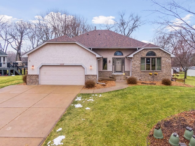 single story home featuring a garage and a front lawn