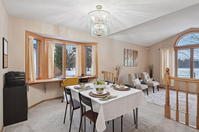 carpeted dining space with a textured ceiling, a chandelier, and vaulted ceiling