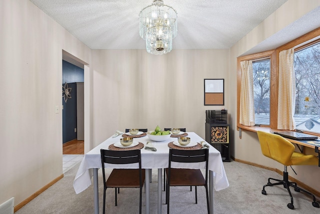 carpeted dining room featuring a textured ceiling and a notable chandelier