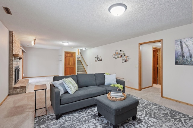 living room with carpet floors, a textured ceiling, and a fireplace