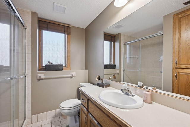 bathroom featuring a textured ceiling, an enclosed shower, tile patterned floors, vanity, and toilet