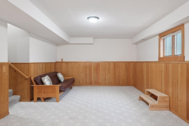 living area with light colored carpet and a textured ceiling