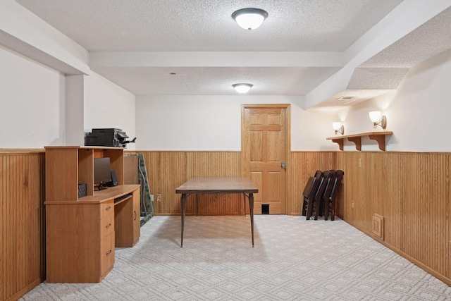 recreation room with wooden walls and a textured ceiling