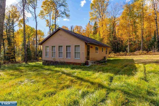 view of property exterior with a yard