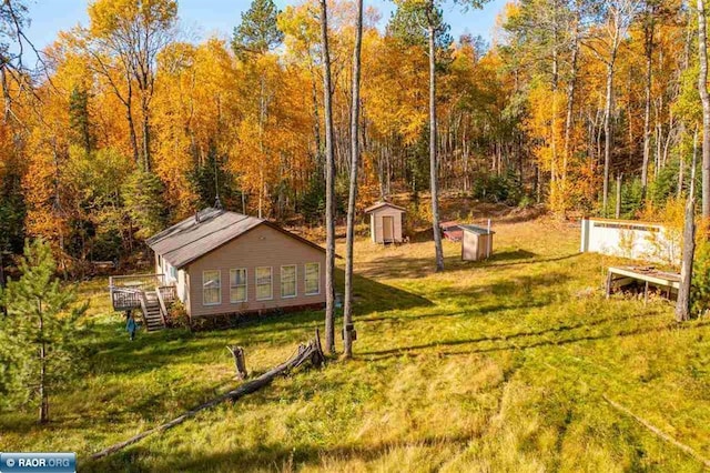 view of yard with a storage shed and a wooden deck