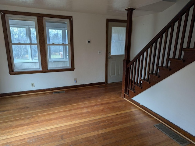 entryway with hardwood / wood-style floors