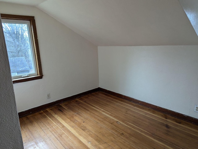 bonus room featuring dark hardwood / wood-style flooring and vaulted ceiling